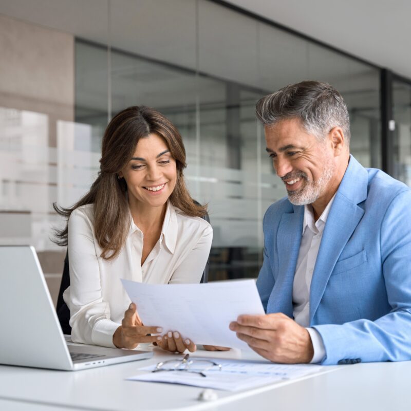 IT leader reviewing agile automation strategy with team across multiple screens in a modern workspace